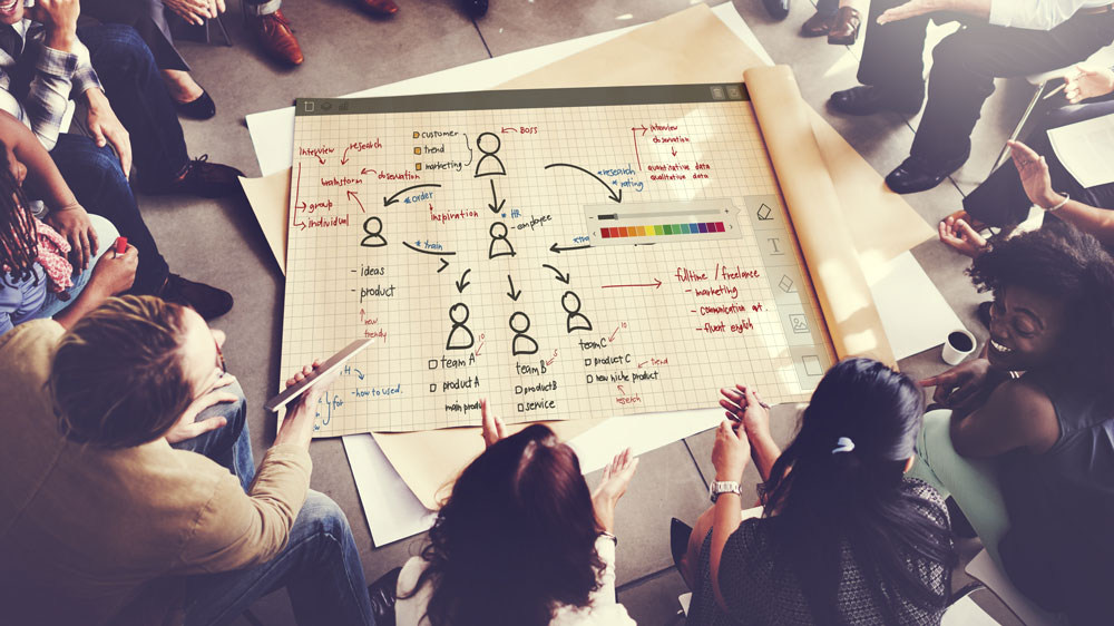 a group of people looking over a game plan